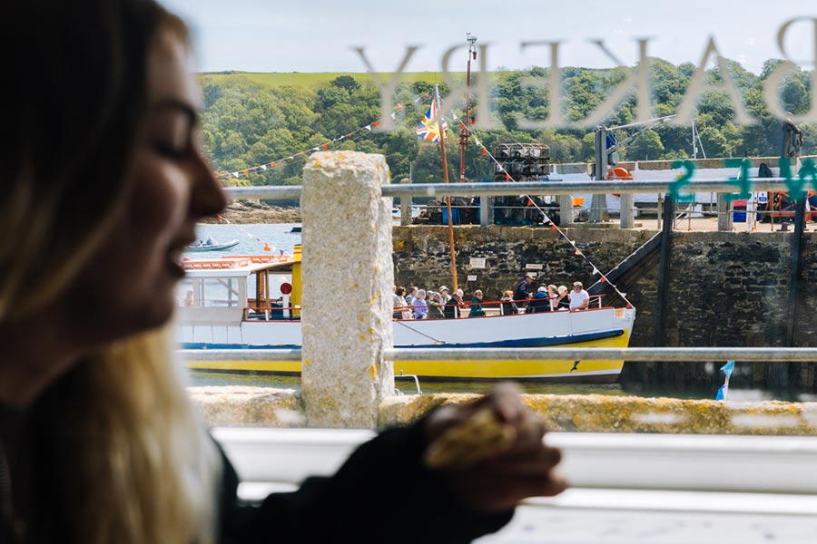Person-by-window-with-boat-outside-St-Mawes-Cafe-gallery-Da-Bara-Bakery