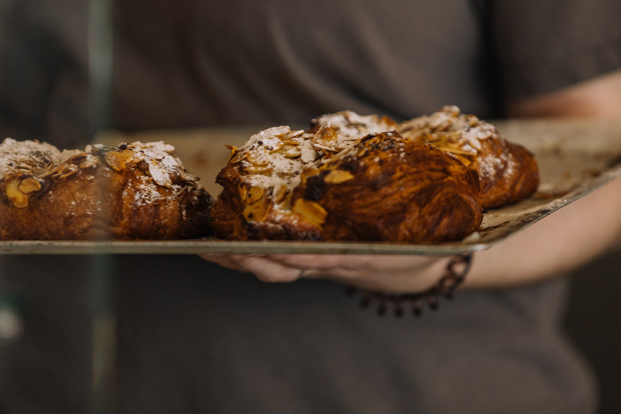 Staff-member-carrying-sweet-treats-in-St-Mawes-Cafe-gallery-Da-Bara-Bakery